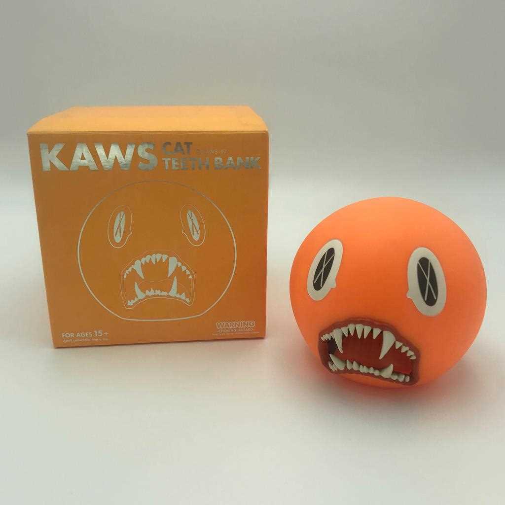 Lot 235 - Kaws (American 1974-), 'Cat Teeth Bank (Orange)', 2007